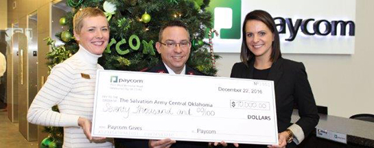 The Salvation Army of Central Oklahoma’s Development Director, Traci Jinkens and Area Commander, Major Carlyle Gargis, stand with Paycom COO Stacey Pezold, during the presentation of Paycom’s record-breaking $70,000 Red Kettle campaign contribution.